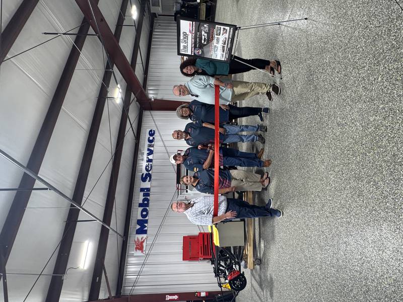 Morris Building and Zoning Officer Bill Martin, Acumen Motorsport owners Doug and Patricia Grunnet, Operations Manager Herb Wyeth, Deb Wyeth, Morris Community Affairs Officer Stan Knudson, and Grundy Chamber President & CEO Christina Van Yperen celebrate the new downtown business with a Chamber ribbon cutting Oct. 9.