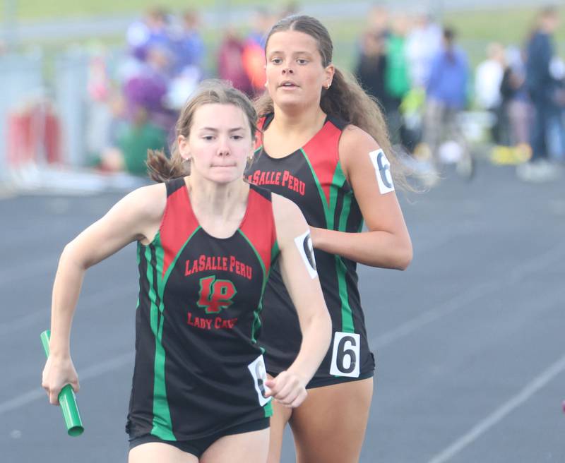L-P's Carla Weitl gets the baton from Politsch in the 4x800 relay during the Class 2A Sectional track meet on Wednesday, May 13, 2026 in the Jeff Prusator Athletic Complex at Mendota High School.