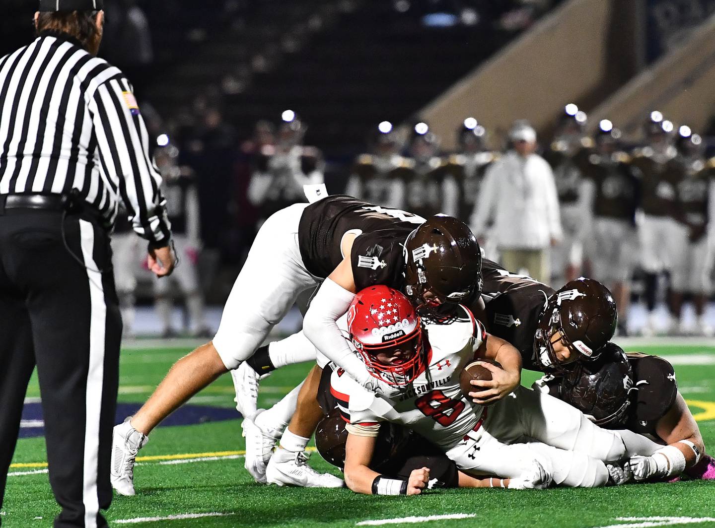 Jacksonville's Braden Hutchison (8) gets tackled by a host of Joliet Catholic's defenders during the IHSA Class 5A first round playoff game on Saturday, Nov 02, 2024 at Joliet. (Dean Reid for Shaw Local News)