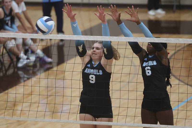 Joliet Catholic’s Jess Horn, left, gets the block against Providence on Thursday, Sept. 14, in Joliet.