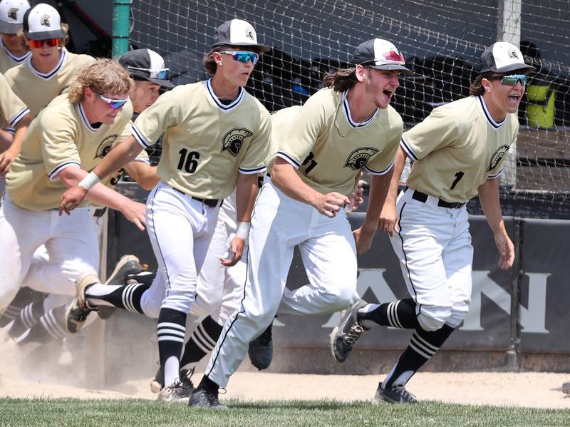 Sycamore players sprint out of the dugout to celebrate after the final out in their Class 3A sectional final win over Burlington Central Saturday, June 3, 2023, at Kaneland High School in Maple Park.