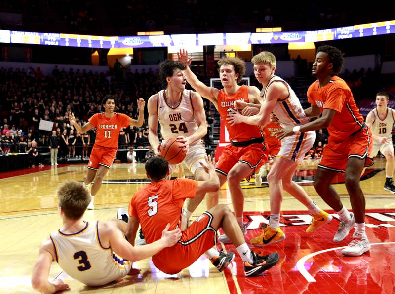 Downers Grove North’s Aidan Akkawi (center) tries to find an opening against the Normal Community defense during the Class 4A Normal Supersectional game on Monday, March 4, 2024.