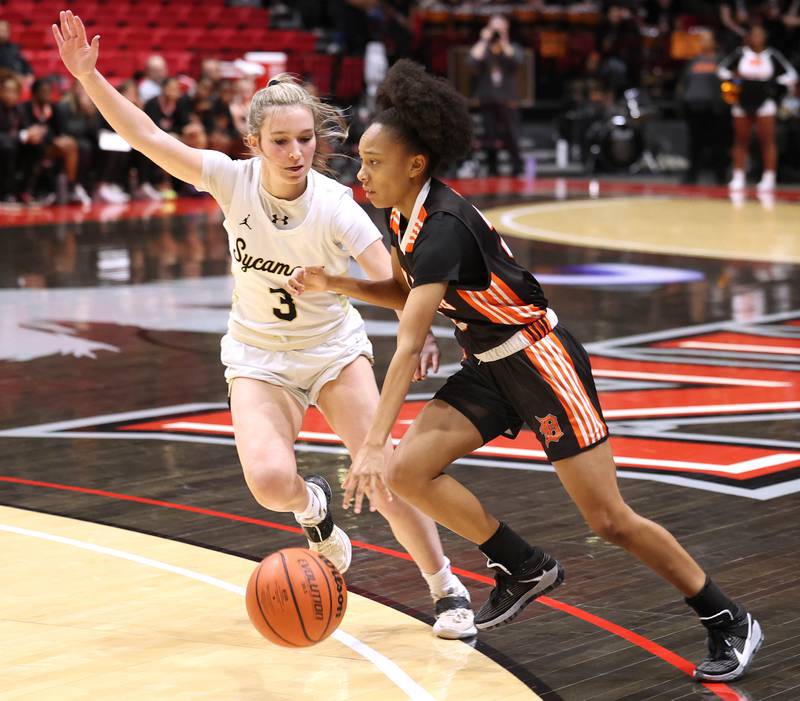 DeKalb's Madison McNeil drives by Sycamore's Malerie Morey during the First National Challenge Friday, Jan. 27, 2023, at The Convocation Center on the campus of Northern Illinois University in DeKalb.