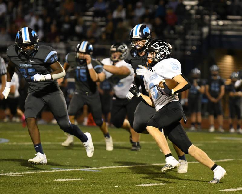 Willowbrook Charlie Siegler, right, runs the ball before being tackled by Downers Grove South defenders on Friday Sep. 15, 2023, during the game held at Downers Grove South.
