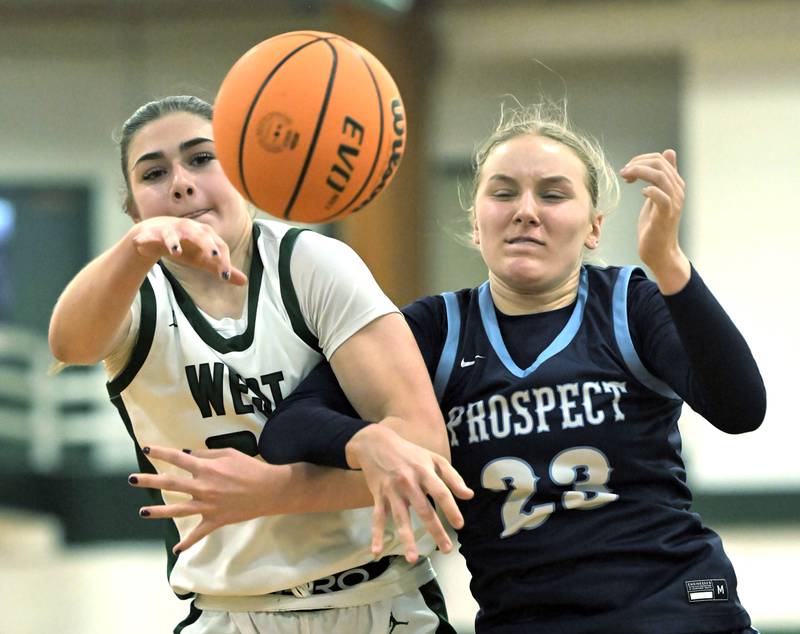 Glenbard West’s Ellie Noble and Prospect’s Allison Linke battle for the ball in a girls basketball game in Glen Ellyn on Thursday, Jan. 9, 2025.