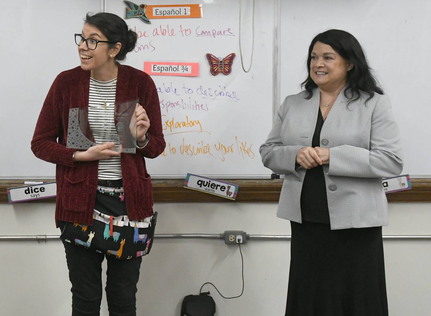Oregon High School teacher Kimberly Radostits holds the award she received from State Superintendent of Education Dr. Carmen I. Ayala (right) for being chosen 2022 Illinois Teacher of the Year. Officials surprised Radostits with the announcement in her classroom on Tuesday morning.