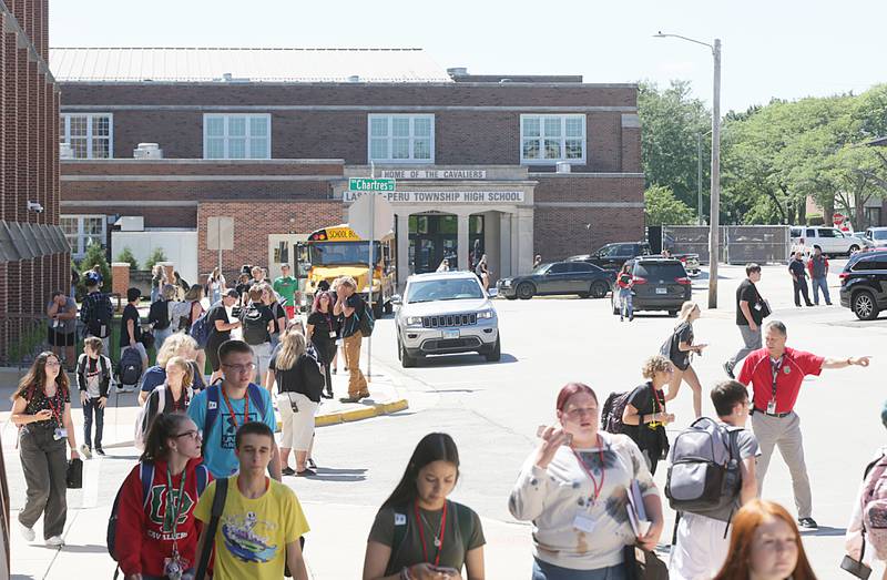 Students exit La Salle-Peru Township High School on the first day of classes on Wednesday, Aug. 10, 2022 in La Salle.
