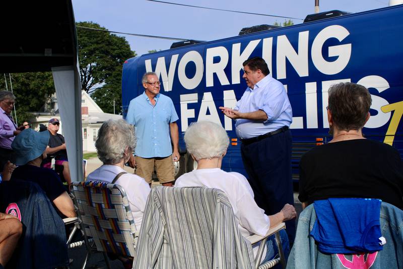 Fidencio Campos, left, chairman of the Whiteside County Democrats listens as Gov. JB Pritzker discusses his administration's accomplishments during a campaign stop Sunday morning at the county Democratic headquarters in Rock Falls.