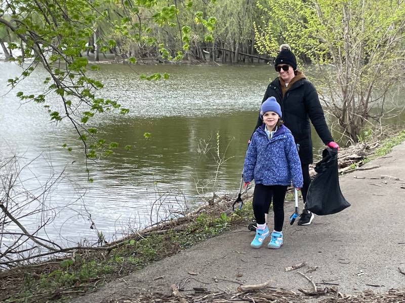 Julia Faletti, 6, of La Salle is all smiles as she and mom Holly Faletti help collect litter near Lock 16 in La Salle during the Earth Day Community Cleanup on Saturday, April 20, 2024. "We try to do it every year," Holly said.