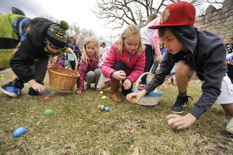 Children rush to grab eggs March 31, 2018, as they take part in the annual Bettendorf Castle Easter Egg Hunt in Fox River Grove.