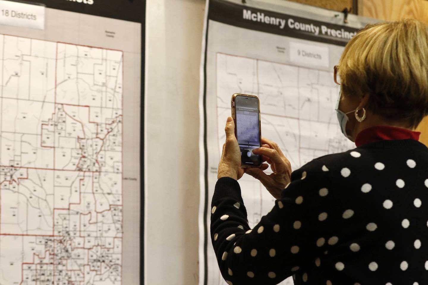McHenry County Board member Kay Bates takes a photo of two proposed County Board district maps presented during a McHenry County Administrative Services Committee meeting on Wednesday, May 5, 2021, in Woodstock.
