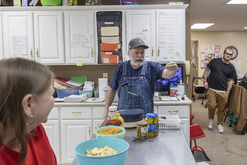 Volunteer Mike Brady chats with clients Wednesday, Jan. 7, 2026, before dinner is served at PADS.