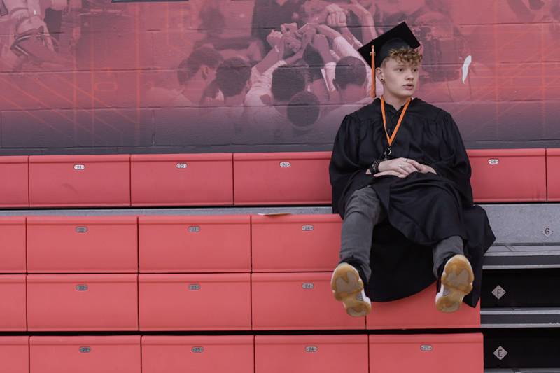 Jack Carpenter sits atop the bleachers as he waits for the DeKalb High School graduation ceremony to start at the Convocation Center in DeKalb on Saturday, May 28, 2022.