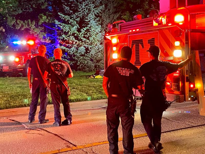 DeKalb firefighters watch as their crew members are hoisted into the air on a ladder truck to help provide light to emergency divers undertaking a water rescue on Sunday, July 27, 2025, in the 600 block of Ridge Drive in DeKalb.