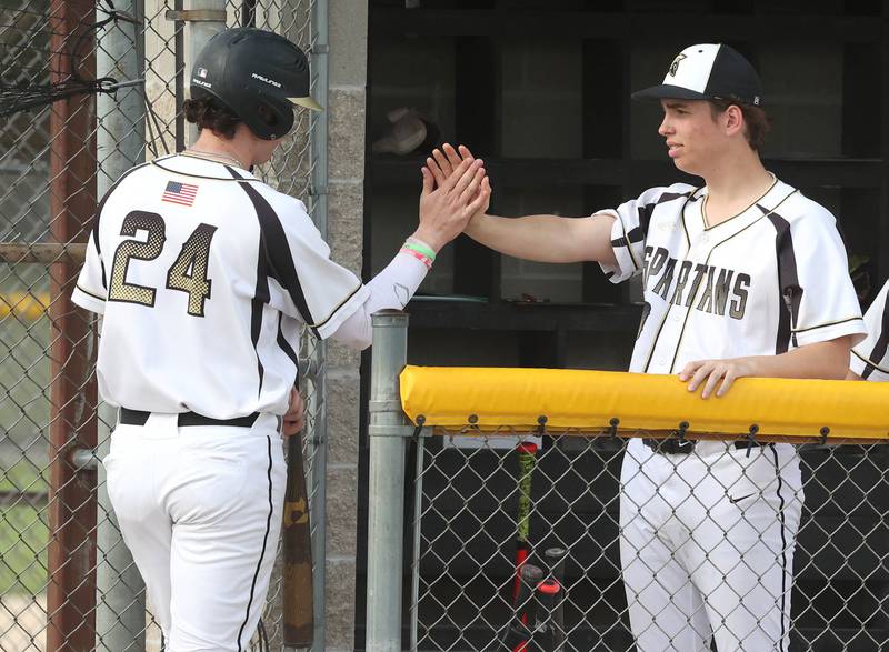Sycamore's Jack Block (left) gets a high-five from Cal Harbecke after driving in a run during their game against Ottawa Tuesday, May 6, 2025, at the Sycamore Community Sports Complex.