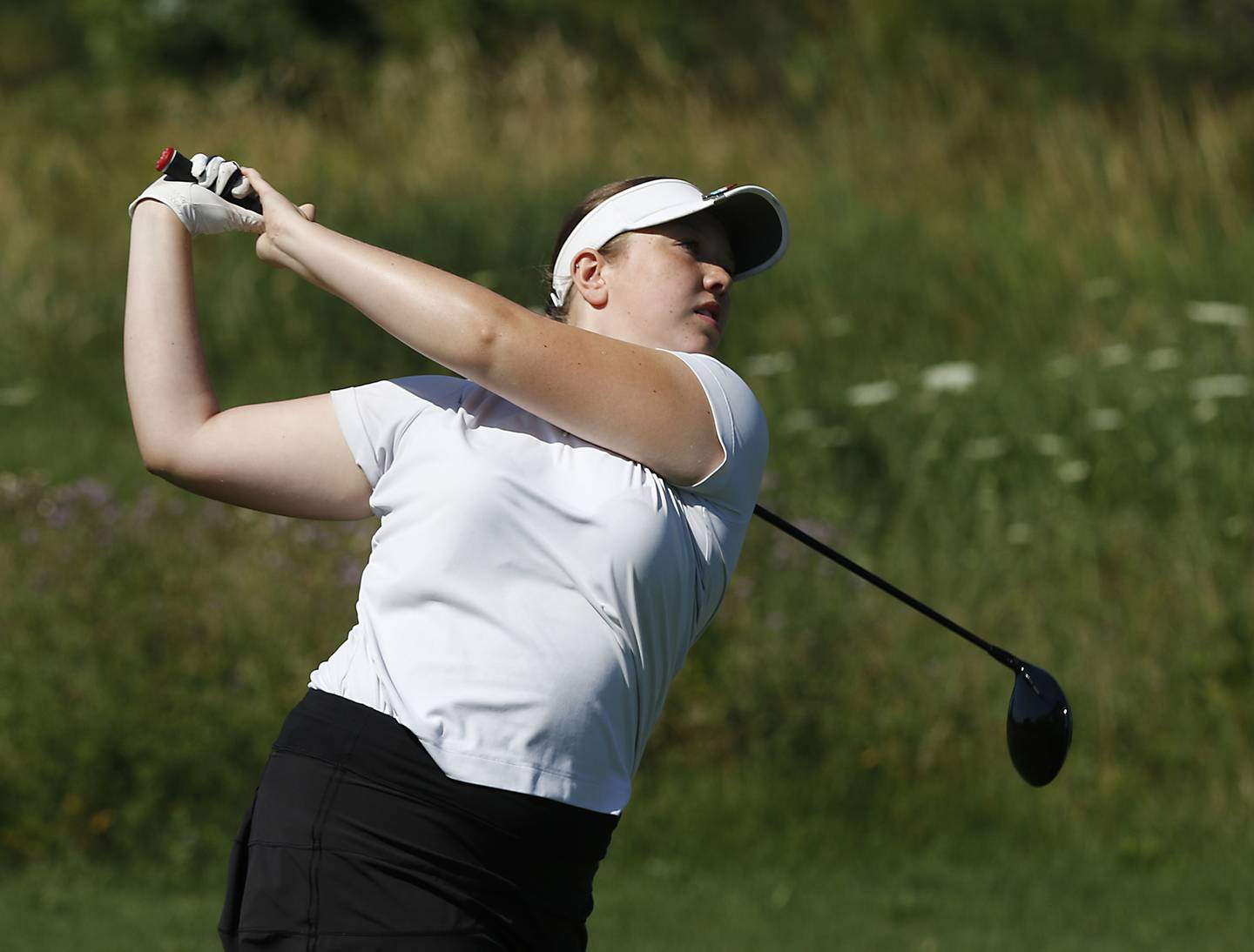 Cary-Grove’s Delaney Medlyn watches her tee shot on the first hole of the Prairie course Wednesday, July 13, 2022, during the second round of the the McHenry County Junior Golf Association's McHenry County Junior Amateur tournament at Boone Creek Golf Club, in Bull Valley.