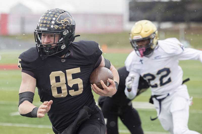 Lena-Winslow's Aiden Wild picks up yards against Althoff Catholic Friday, Nov. 29, 2024, in the class 1A football state final.