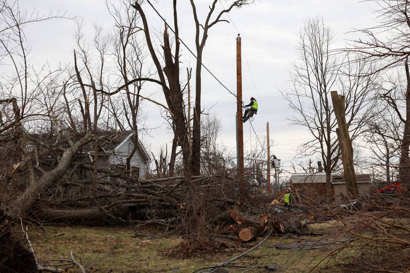 Electrical workers make progress to repairing power lines in Aroma Township on March 14, 2026, following the March 10 tornado in Kankakee County.