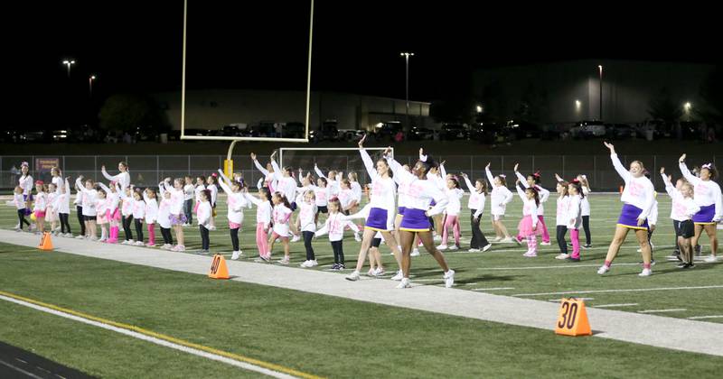 Mendota cheerleaders perform with children at halftime on Friday, Oct. 11, 2024 at Mendota High School.