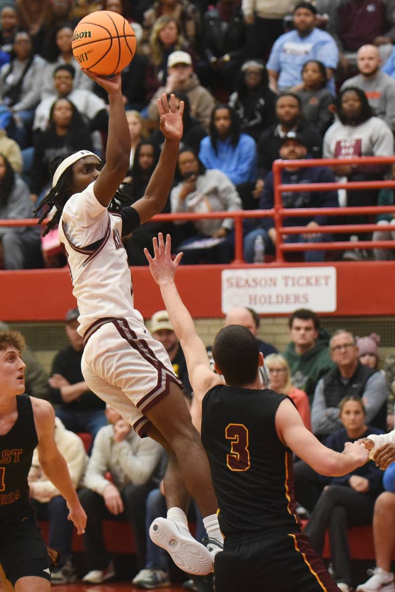 Kankakee's Cedric Terrell III, left, takes a shot while East Peoria's Cole DuBois defends during the IHSA Class 3A Ottawa Sectional semifinals Wednesday, March 4, 2026.