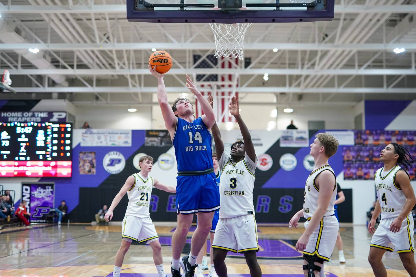 Hinckley-Big Rock's Martin Ledbetter (14) shoot the ball in the post against Yorkville Christian's Jayden Riley (3) during a basketball game in the opening round of the 61st annual Plano Christmas Classic at Plano High School on Monday, December 23, 2024.