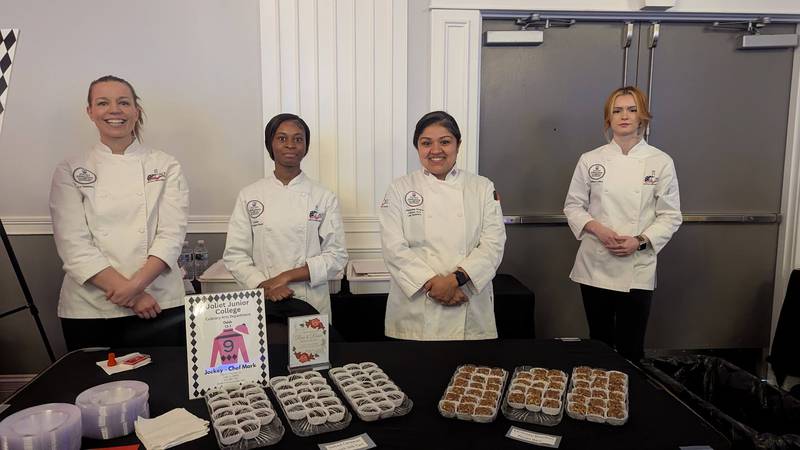 Members of the Joliet Junior College culinary program pose behind their table  at the Shorewood HUGS annual chocolate ball on Saturday, February 1, 2025, in joliet. Pictured, from left, are Ivy Watkins, Arrington-Reed, Stephanie Rivera and Madison Collins.