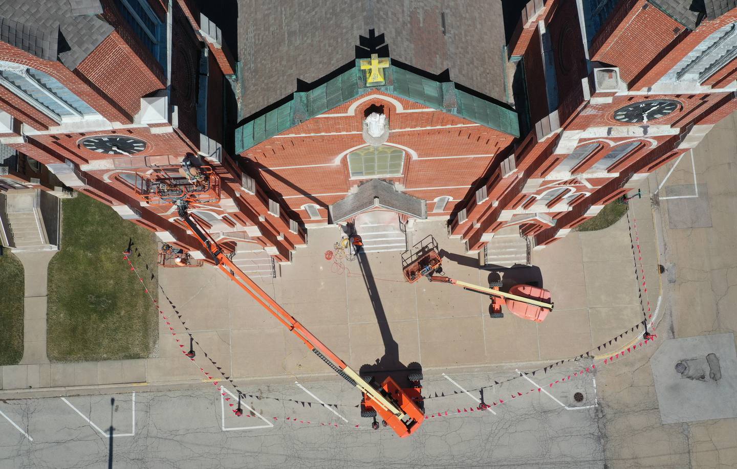 Workers tuckpoint spires on St. Hyacinth's Catholic Church on Tuesday, March 14, 2023 in La Salle. Last May, the church launched a $1.8 million capital campaign for a new roof, facade improvements and interior work.