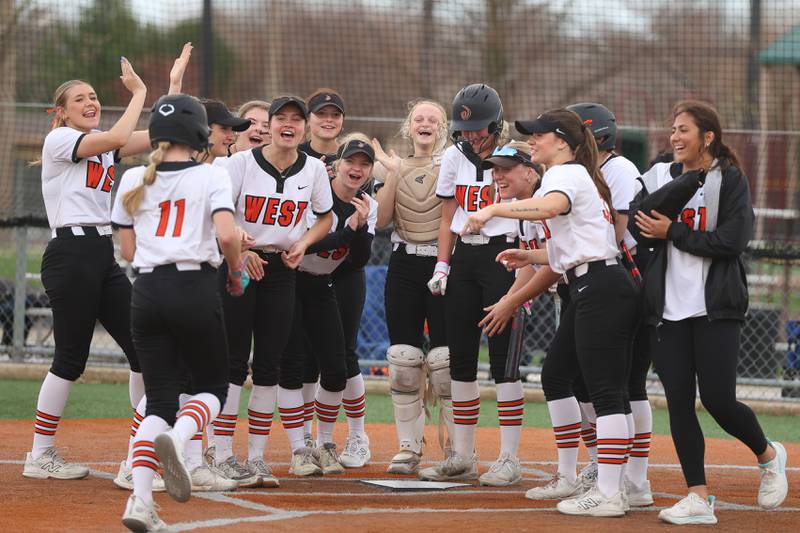 Lincoln-Way West’s Reegan Connolly is greeted at home plate after her two run home run against Lockport in the WJOL Softball Tournament championship game on Thursday, April 2, 2026 in Joliet.