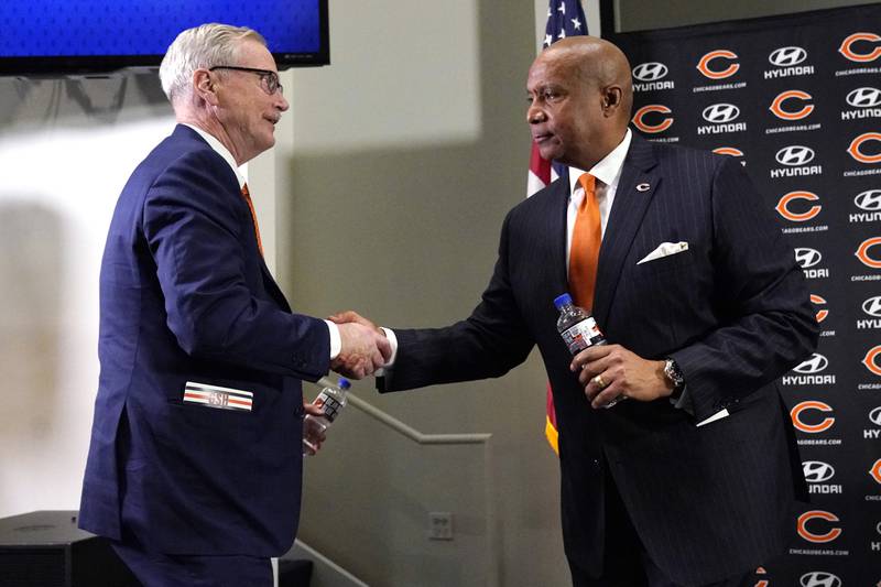 Chicago Bears Chairman George H. McCaskey, left, shakes hands with new President & CEO Kevin Warren, Tuesday, Jan. 17, 2023, at Halas Hall in Lake Forest.