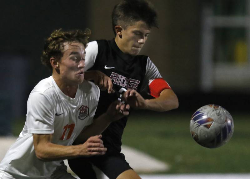 Crystal Lake Central's Mason McIntyre battles to get to the ball with Prairie Ridge's Joshua Marineau during the IHSA Boys Soccer 2A Grayslake Central Sectional semifinal match on Tuesday, Oct. 29, 2024, at Grayslake Central High School.
