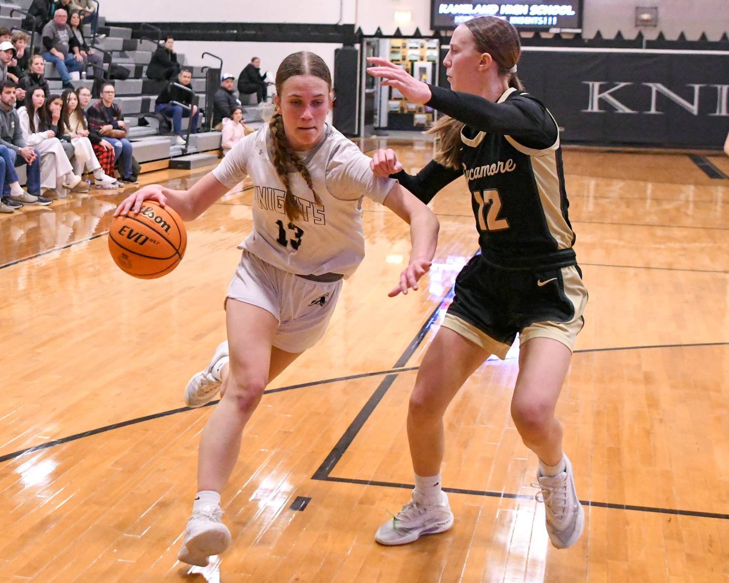 Kaneland's Grace Brunscheen (13) tries to get around Sycamore's defender Sadie Lang (12) during the game on Wednesday Feb. 4, 2026, held at Kaneland High School.