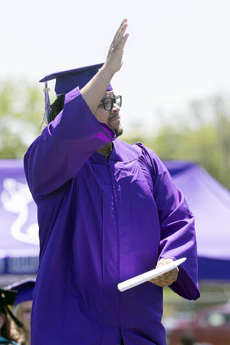 Dylan Bopes waves to the crowd Sunday, May 24, 2026, after receiving his diploma from Dixon High School.
