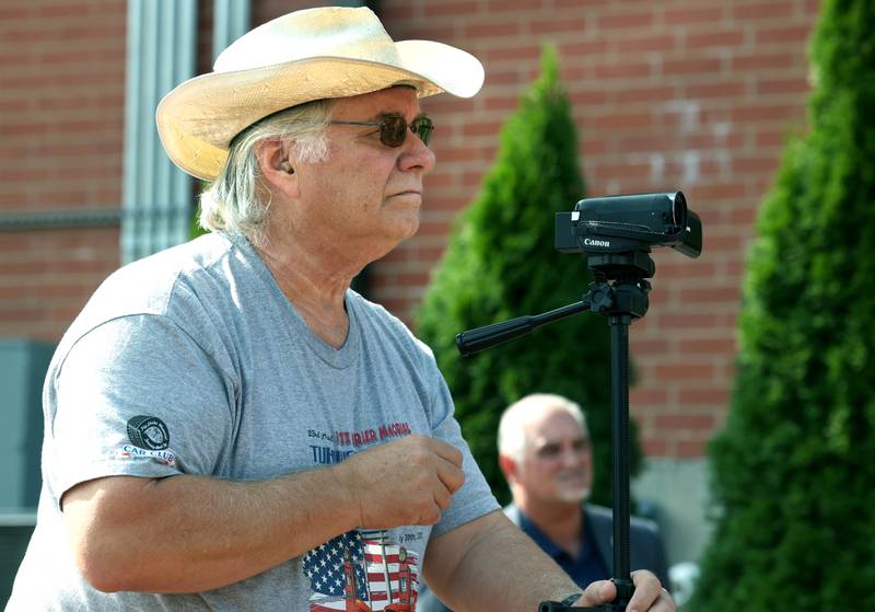 Mike Tritle, from DeKalb, shoots video Thursday, Aug. 22, 2024, during the DeKalb Veterans Memorial Mural dedication in Van Buer Plaza in DeKalb. Tritle captures the stories of veterans on video during at community events in the area.