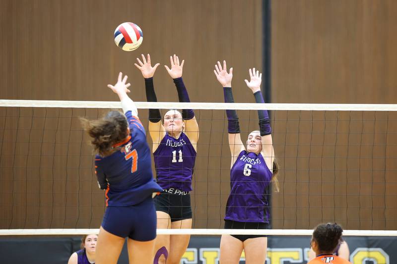 Wilmington's Molly Southall and Aly Allgood, right, reach to block a hit during the Wildcats' loss in three sets, 25-16, 22-25, 17-25, to Pontiac in the IHSA Class 2A Herscher Regional championship on Thursday, Oct. 30, 2025.