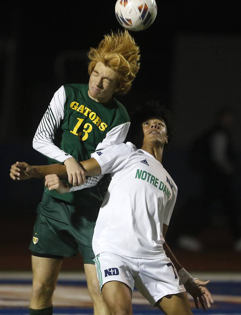 Crystal Lake South's Pierce Johnson heads the ball away from Peoria Notre Dame's Kayden Hudson during the IHSA Class 2A state championship soccer match on Saturday, Nov. 4, 2023, at Hoffman Estates High School.