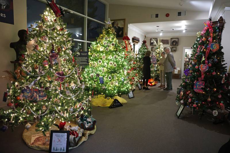 Attendees admire trees at the Kankakee County Museum during the kickoff event for the 47th annual Gallery of Trees on Wednesday, Dec. 3, 2025.