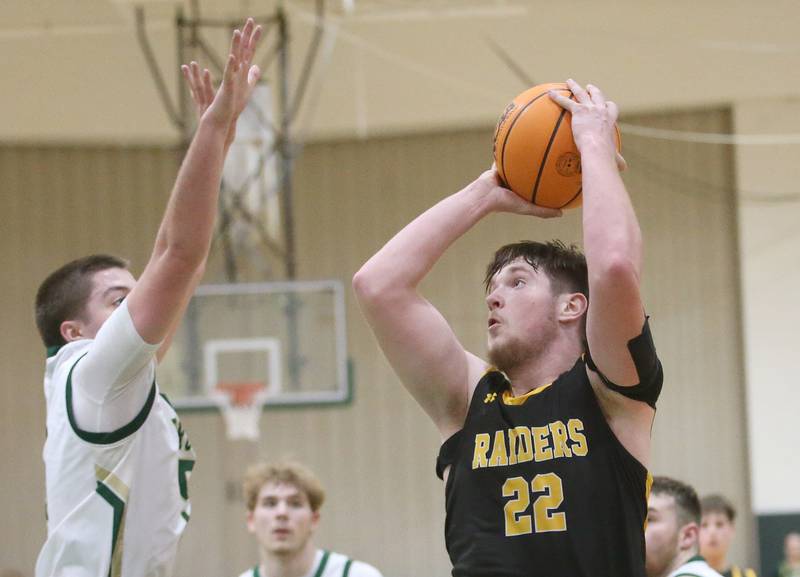 Ashton-Franklin Center's Brock Lehman eyes the hoop as St. Bede's Halden Hueneburg defends the lane during the Class 1A Regional quarterfinal game on Monday, Feb. 24, 2025 at St. Bede Academy.