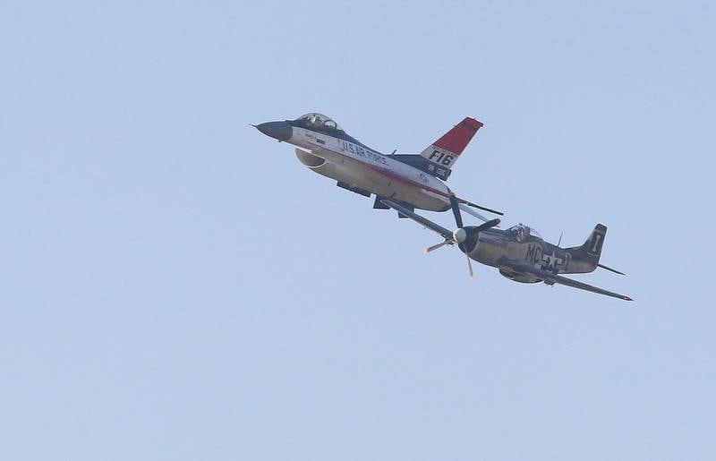 A P-51 Mustang flies next to the Viper F-16 Demo Team aircraft during the 10th annual TBM Avenger Reunion and Airshow on Friday, May 16, 2025 at the Illinois Valley Regional Airport in Peru.