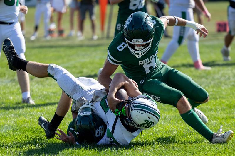 Tysen Walker (20) of Dwight is brought down by Amryn Wiles (8) of St. Bede and teammate Landon Hoffner (1) on Saturday, Oct. 4, 2025 at Captain Thomas J. Heitmann field in Peru.