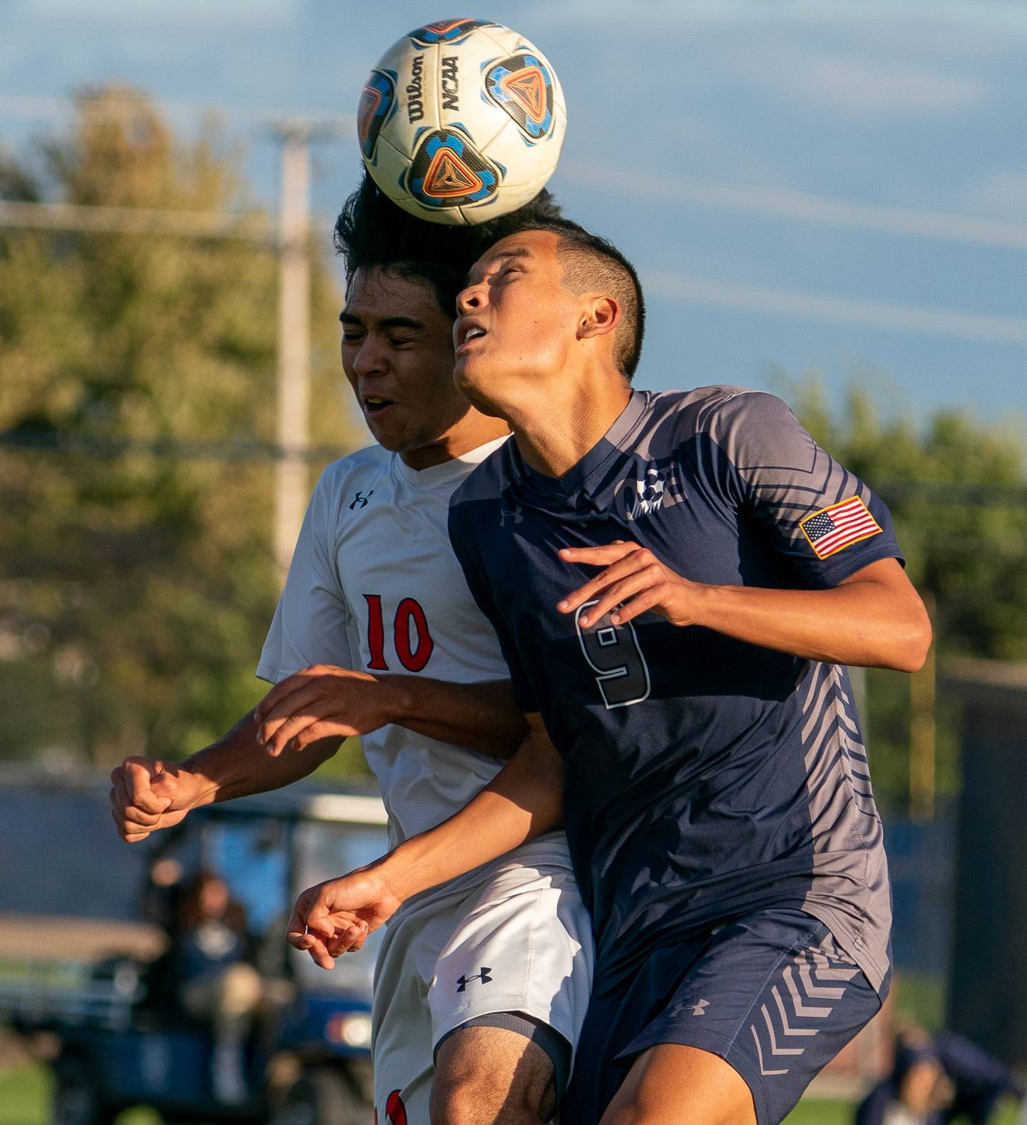 Oswego East's Dupablo Parodis-Yu (9) plays the ball on a header against Oswego’s Killyan Avila (10) during a soccer match at Oswego East High School on Monday, Sep 26, 2022.