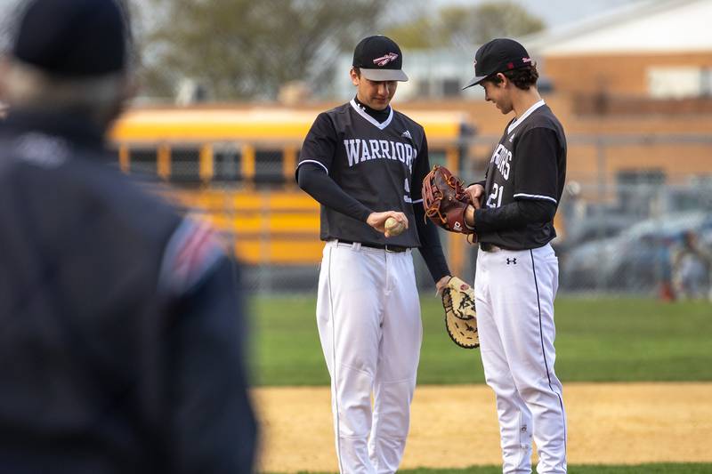 Sam Schmitz (9) and Reece Pelnarsh (21) of Woodland/Flanagan-Cornell talk on mound on Thursday, April 17, 2025 at Woodland High School in Streator.