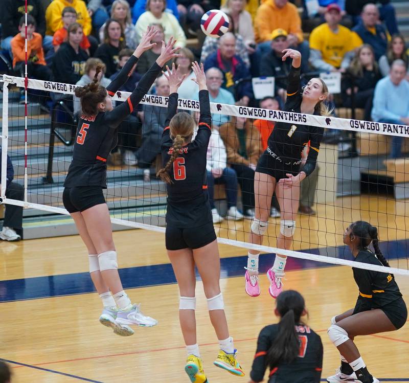 Joliet West's Ava Grevengoed (1) goes up for a kill attempt against Lincoln-Way West's Caroline Smith (5) and Lily Goyer (6)during a class 4A Oswego Sectional semifinal match at Oswego High School on Monday, Oct. 30, 2023.