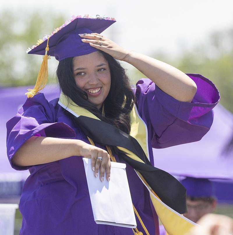 Lilyana Herrera holds onto her hat Sunday, May 24, 2026, after receiving her diploma from Dixon High School.