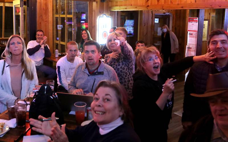 Republicans and supporters watch as results come in during an election night watch party for local republicans at Niko's Red Mill Tavern on Tuesday, Nov. 3, 2020 in Woodstock.