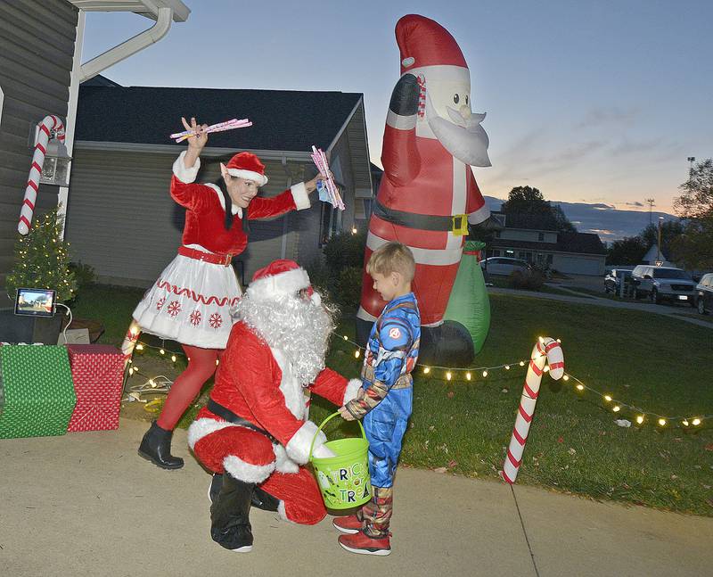 Trick or Treaters were a bit confused as to what holiday it was at the Mason residence on Heritage on Ottawa’s South side Friday evening as Santa and his elf greeted those seeking a candy treat.