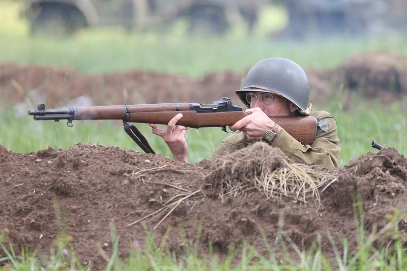 A US soldier takes fire from the trench during the WWII battle re-enactment at Lockport Military History Days at Dellwood Park on Saturday, Sept. 9, 2023 in Lockport.