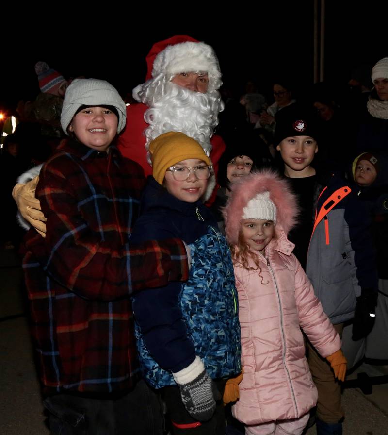 Santa poses for photos with children at the Sugar Grove Holiday Tree Lighting Ceremony on Friday, Dec. 6, 2024.