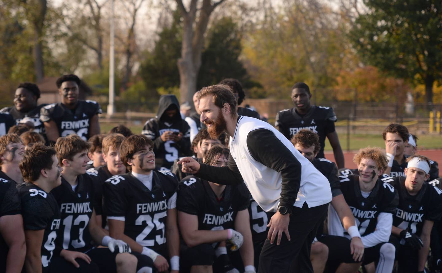 Fenwick's players and coach celebrate their victory against Brother Rice during the playoff game Saturday, Nov. 2, 2024.