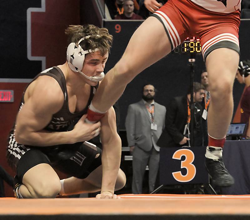 Joliet Catholic’s Nico Ronchetti tries to control Ricky Ericksen of Marist in the 190-pound Class 3A final at the IHSA boys state wrestling Championships at the State Farm Center in Champaign on Saturday, Feb. 22, 2025.