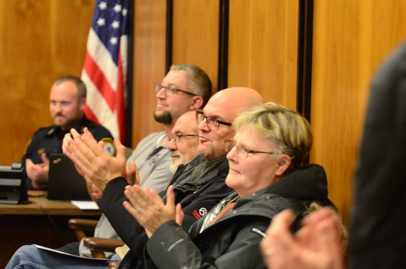 Former Rock Falls Fire Chief Ken Wolf III (center) claps as his successor is sworn in Tuesday, Jan. 20, at the Rock Falls City Council meeting.